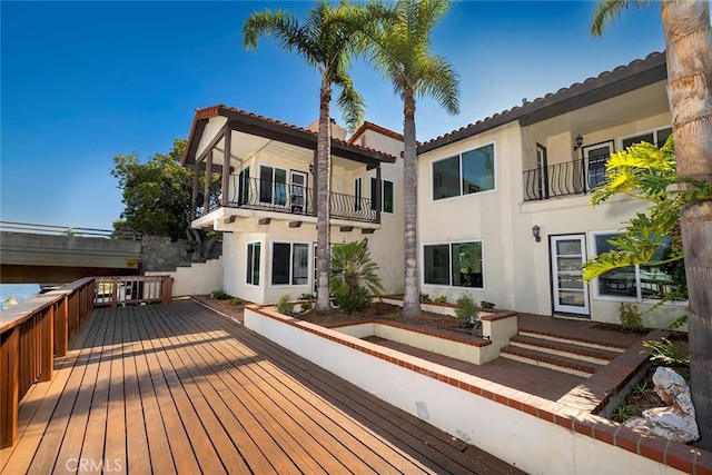 rear view of property featuring a balcony