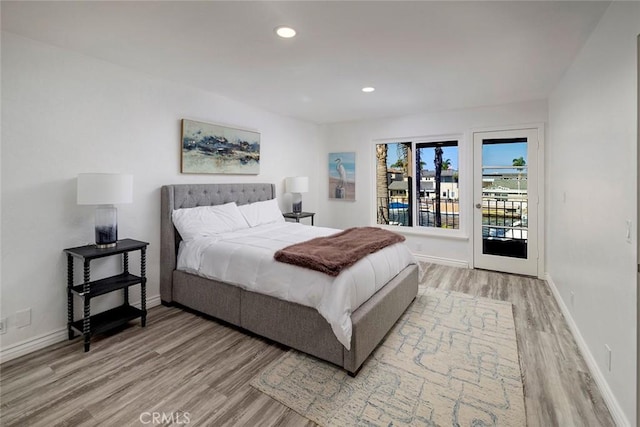 bedroom with access to exterior and wood-type flooring