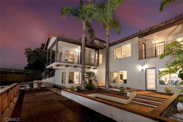 16592 Grimaud Ln, Huntington Beach, CA 92649 - back of house with a balcony and stucco siding