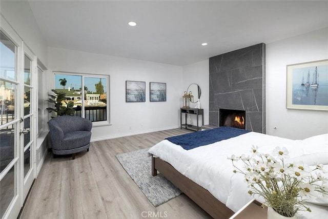 16592 Grimaud Ln, Huntington Beach, CA 92649 - bedroom featuring wood finished floors, recessed lighting, a large fireplace, and baseboards