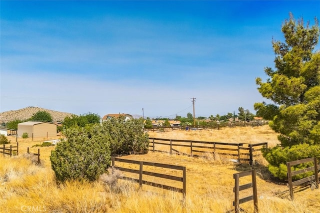 view of yard with a rural view