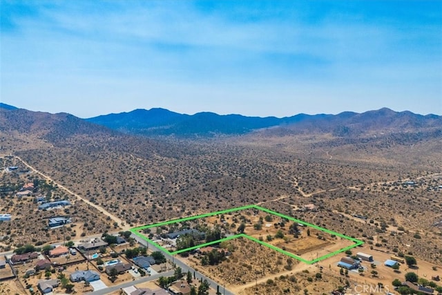 birds eye view of property with a mountain view