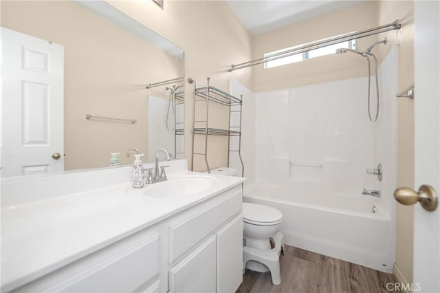 full bath with shower / bathing tub combination, vanity, toilet, and wood finished floors