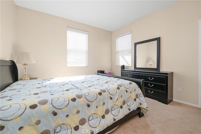 carpeted bedroom featuring baseboards