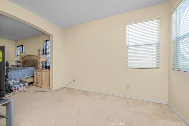 carpeted bedroom featuring baseboards