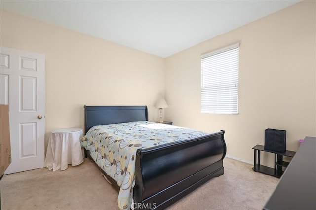 carpeted bedroom featuring baseboards