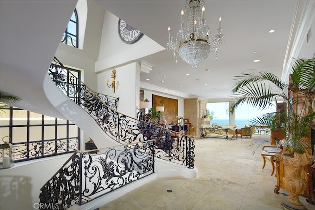 staircase featuring crown molding and a notable chandelier