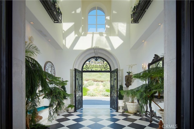 foyer featuring a towering ceiling