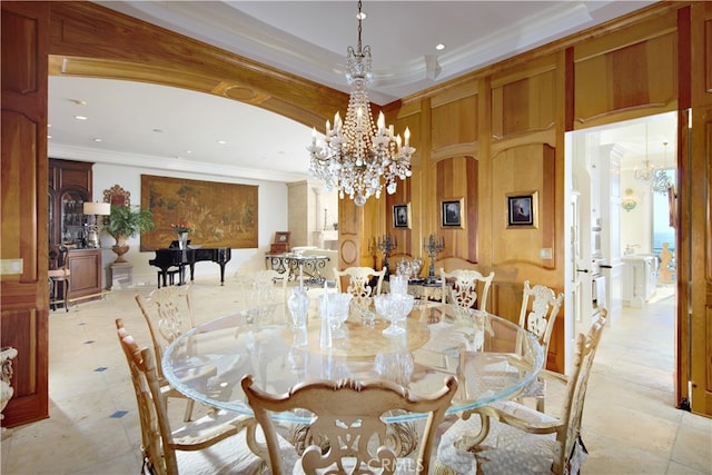 dining area with crown molding and a notable chandelier