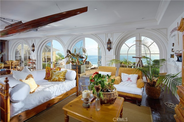 bedroom featuring crown molding and a water view