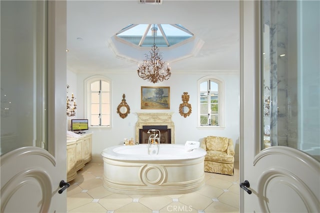 bathroom featuring vanity, ornamental molding, an inviting chandelier, and tile patterned floors