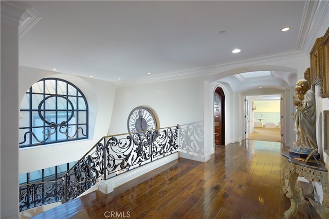 hallway with crown molding, wood-type flooring, and a wealth of natural light