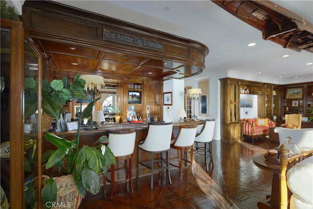 bar featuring crown molding and dark parquet flooring