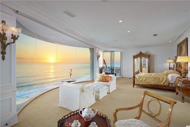 carpeted bedroom featuring crown molding and a water view