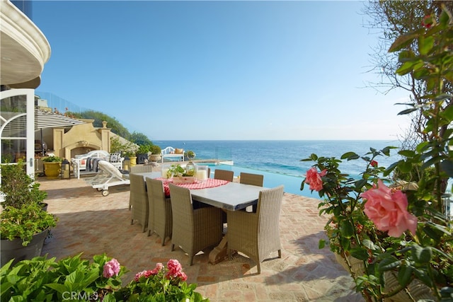 view of patio / terrace featuring a view of the beach and a water view