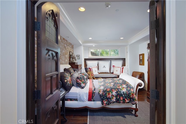 bedroom featuring crown molding and dark hardwood / wood-style flooring