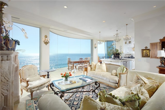 living room with an inviting chandelier, ornamental molding, and a water view