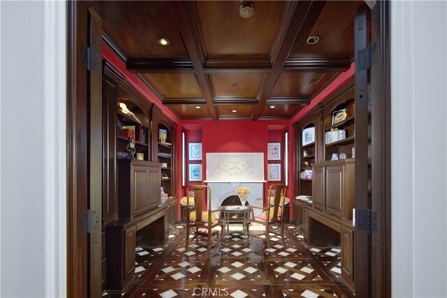 office featuring ornamental molding, beamed ceiling, coffered ceiling, and built in features