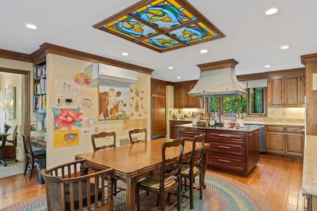 dining space featuring light wood-type flooring and an AC wall unit