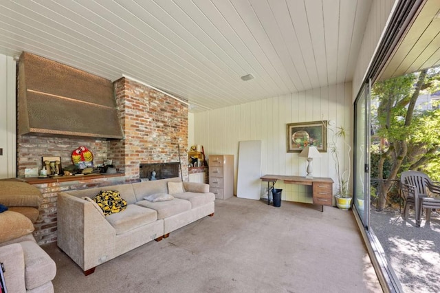 living room featuring wooden walls and a brick fireplace