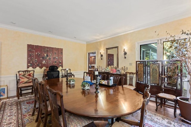 dining space featuring hardwood / wood-style floors and ornamental molding