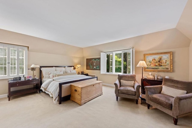 bedroom featuring light colored carpet and vaulted ceiling