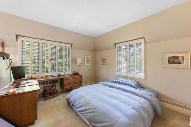 carpeted bedroom featuring vaulted ceiling and radiator