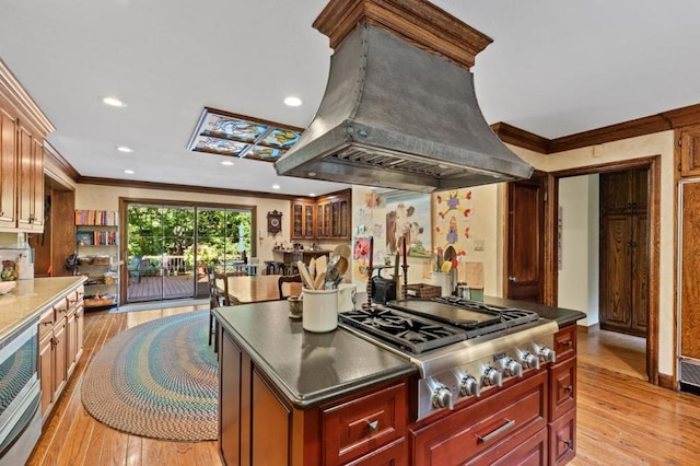 kitchen with island range hood, ornamental molding, light hardwood / wood-style floors, and stainless steel gas cooktop