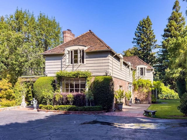 view of side of home with a lawn