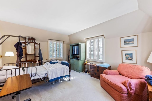 bedroom with light carpet and vaulted ceiling