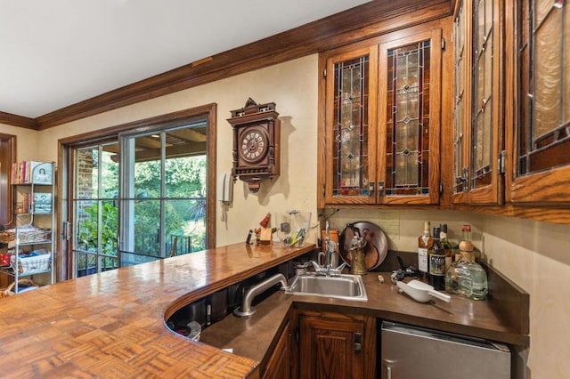 bar featuring dishwasher, sink, and crown molding