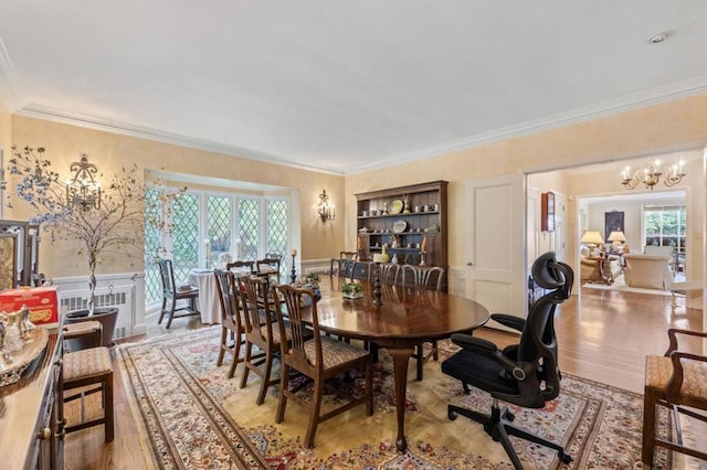 dining room with plenty of natural light, light wood-type flooring, and crown molding