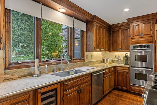 kitchen featuring a healthy amount of sunlight, sink, stainless steel appliances, and wine cooler