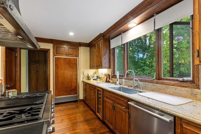 kitchen with a wealth of natural light, exhaust hood, dark wood-type flooring, and appliances with stainless steel finishes