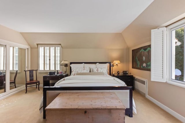 bedroom with light carpet, radiator, and lofted ceiling