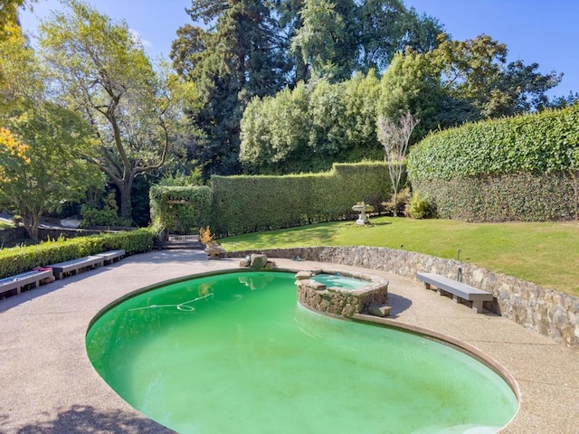 view of pool with a yard and an in ground hot tub