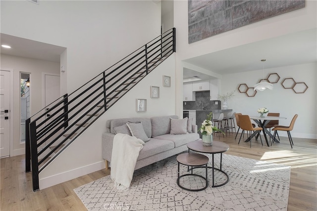 living room featuring light hardwood / wood-style floors and sink