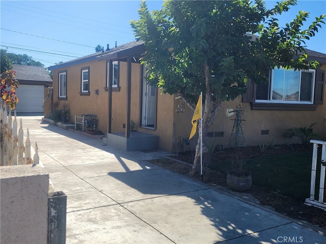 1620 E Mcmillan, Compton, CA 90221 - view of front of home featuring stucco siding, an outbuilding, driveway, and a garage