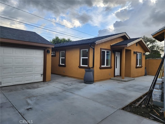 1620 E Mcmillan, Compton, CA 90221 - view of property exterior with a garage, stucco siding, and driveway