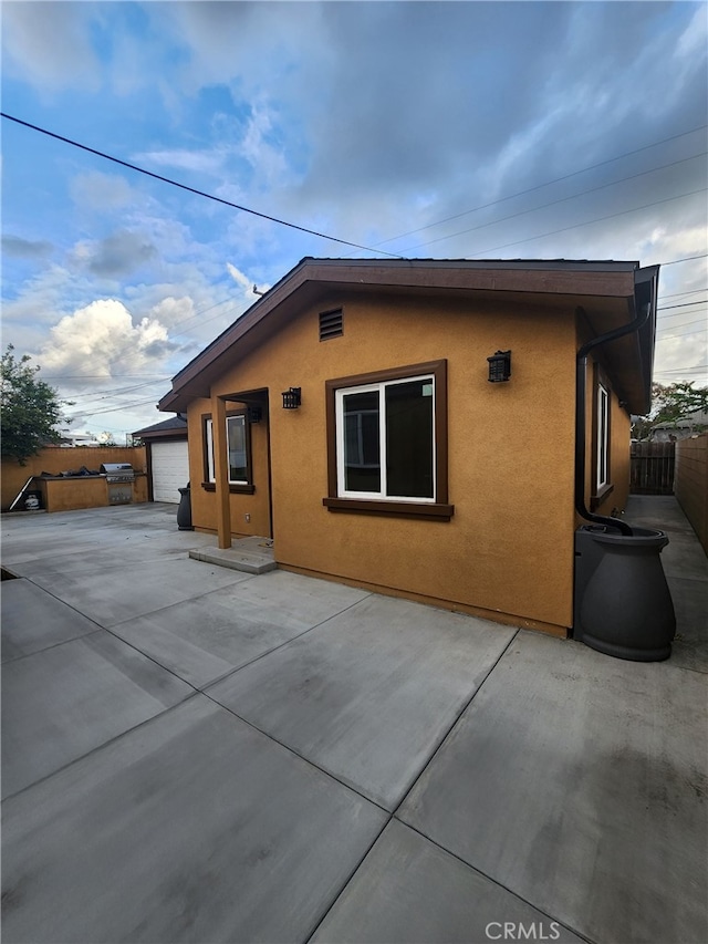 view of home's exterior featuring a patio and a garage