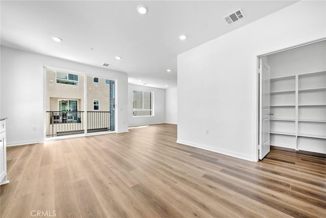 unfurnished living room with light hardwood / wood-style flooring