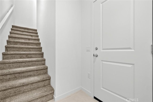 staircase with tile patterned floors