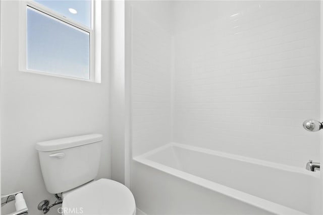 bathroom featuring shower / bathtub combination and toilet