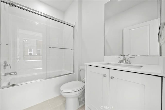 full bathroom featuring toilet, tile patterned flooring, vanity, and combined bath / shower with glass door