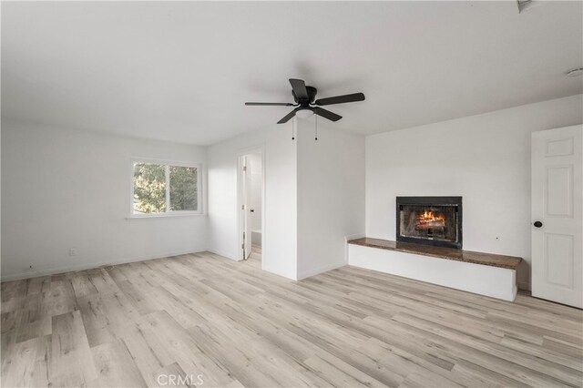 unfurnished living room featuring light hardwood / wood-style floors and ceiling fan