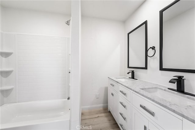 bathroom featuring shower / bathtub combination, vanity, and hardwood / wood-style flooring