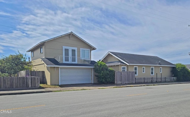 view of front of house with a garage and a balcony