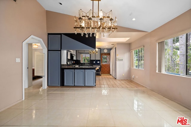 kitchen featuring light tile patterned flooring, lofted ceiling, decorative backsplash, and decorative light fixtures