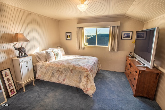 bedroom with dark colored carpet and lofted ceiling