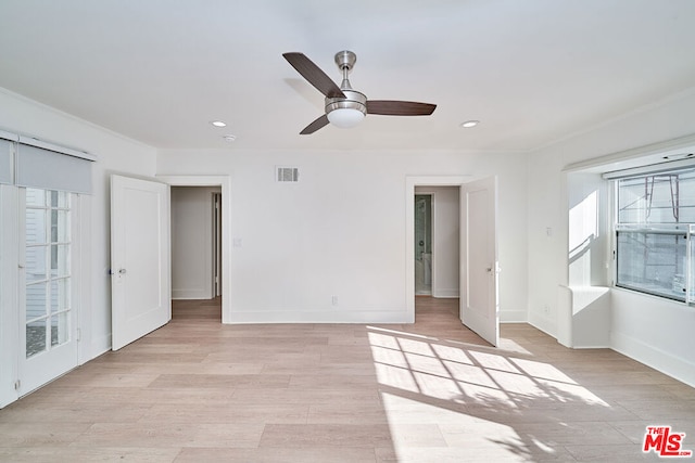 unfurnished room featuring light hardwood / wood-style flooring, ceiling fan, and ornamental molding